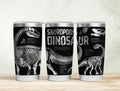 Three tumblers with dinosaur skeleton designs on a wooden surface.