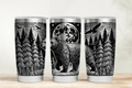 Three tumblers with black and white nature-themed designs on a wooden surface.