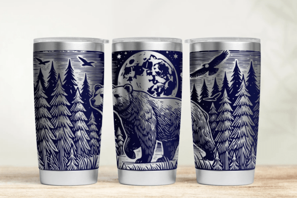 Three tumblers with nature-themed designs on a wooden surface.