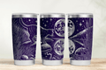 Three purple tumbler cups with celestial designs on a wooden surface.