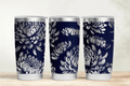 Three tumblers with floral pattern on a wooden surface and light gray background