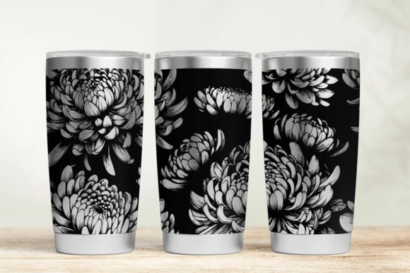 Three tumblers with black and white floral patterns on a wooden surface.
