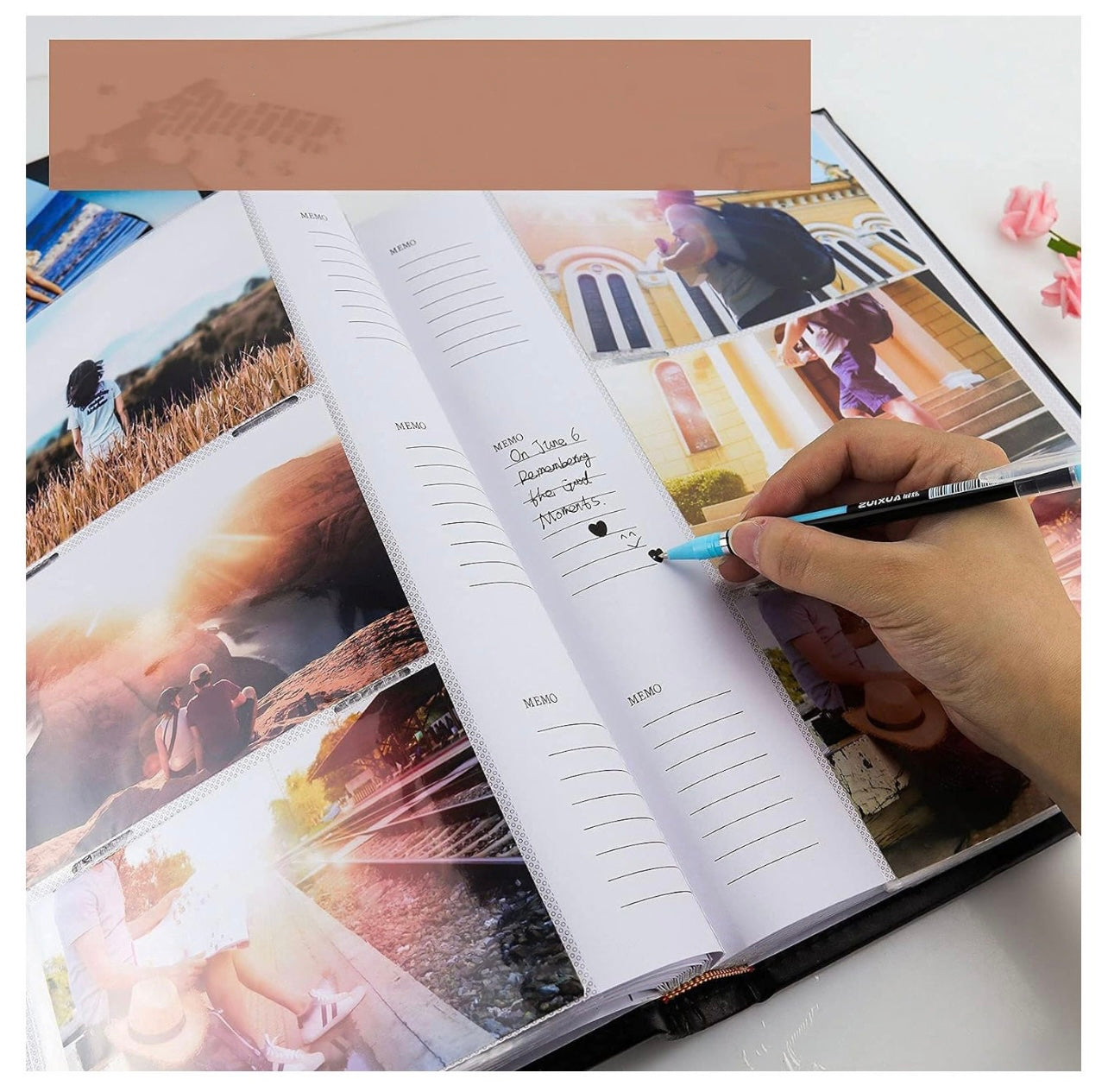 Open photo album with scenic images and a hand writing in a lined notebook page.