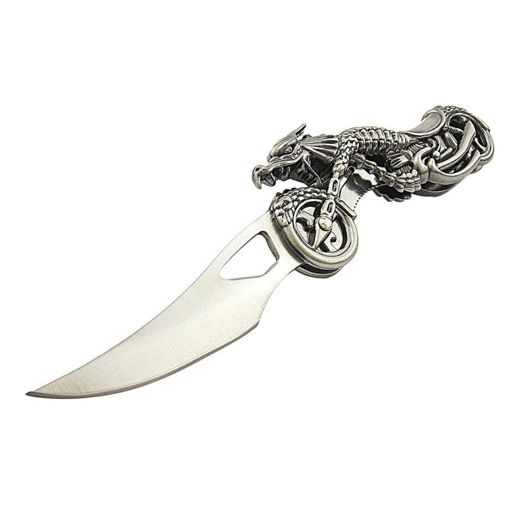 Decorative metal knife with dragon design on a motorcycle