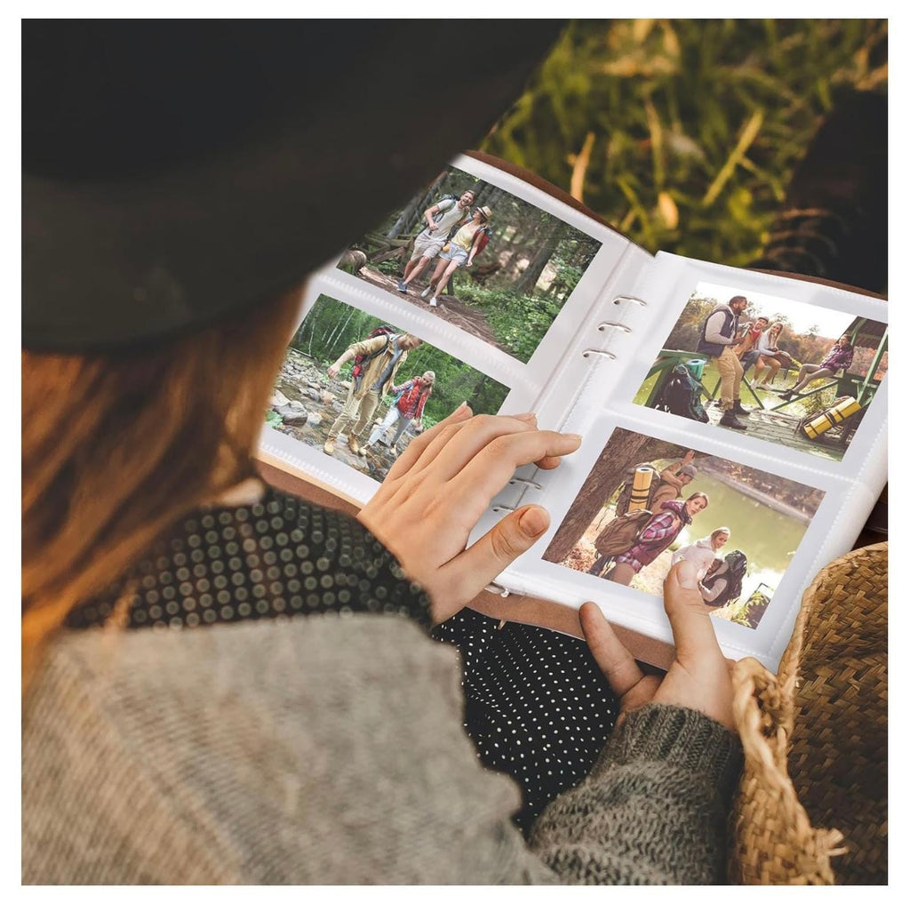 Person flipping through a photo album with images of people outdoors.