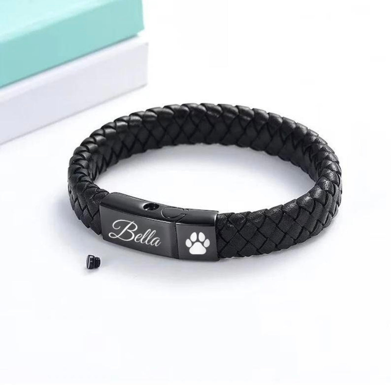 Black braided leather bracelet with engraved name and paw print on a white background