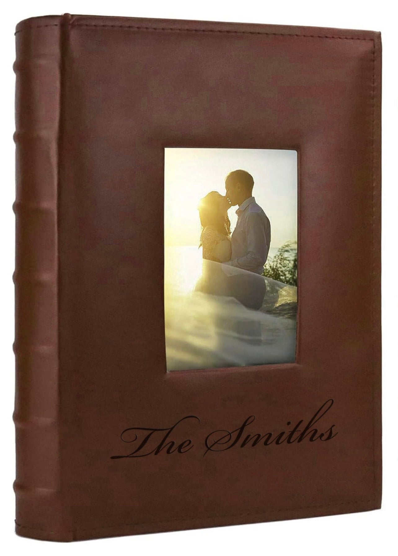 Brown leather photo album with engraving and a picture of a couple on the cover.