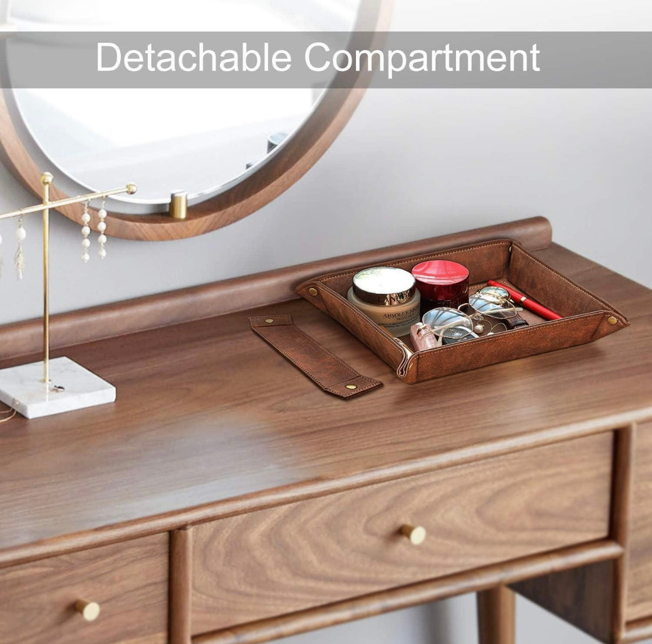 Wooden vanity with a detachable compartment tray containing makeup items, with a mirror in the background.