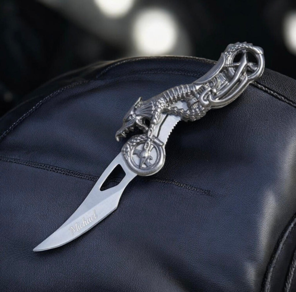 Decorative knife with a black handle on a dark surface