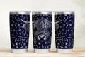 Three tumblers with highland cow design on a wooden surface