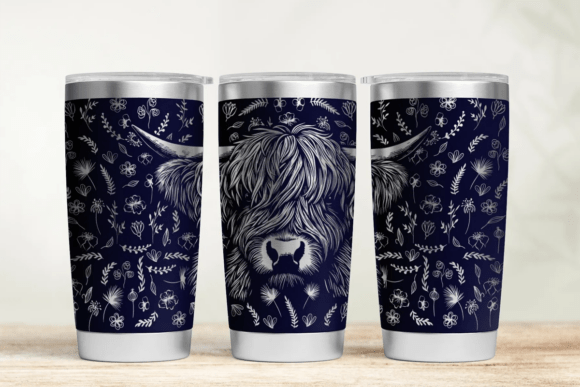 Three tumblers with highland cow design on a wooden surface