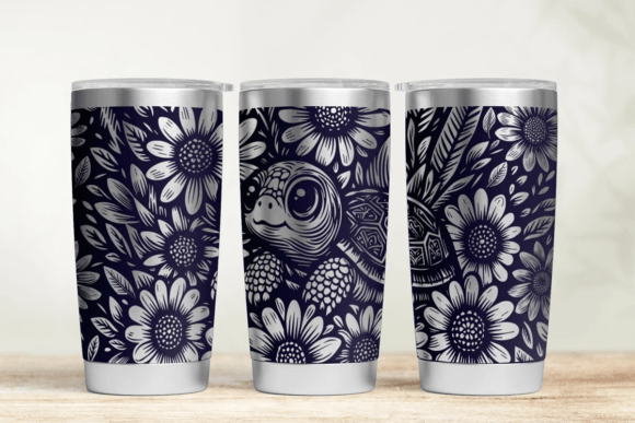 Three tumblers with floral and nature-themed designs on a wooden surface.