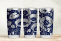 Three tumblers with floral design on a wooden surface and light background